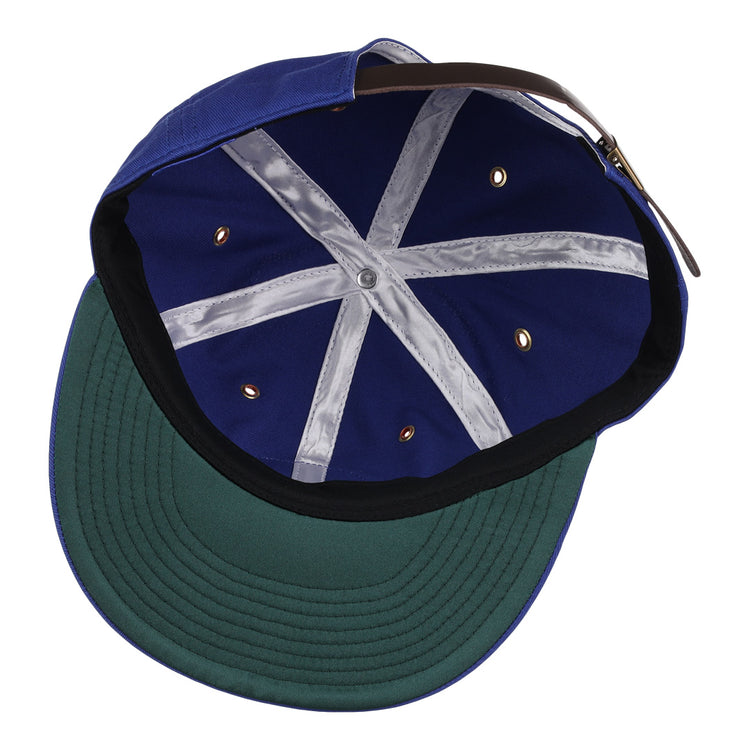 The EFF Reddy Kilowatt Cotton Twill Ballcap from the summer series is displayed inside-out, showing a green brim, black sweatband, silver seams, gold grommets, and an adjustable brown strap at the back.