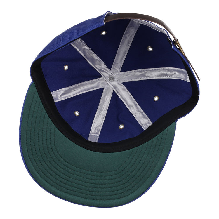 Inside the EFF Santurce Cangrejeros Cotton Twill Ballcap: a green underbrim, navy blue interior, X-pattern grey taped seams, metal ventilation holes, and an adjustable brown strap at the back.