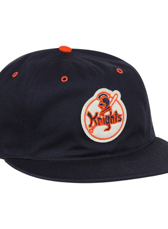 The EFF New York Knights Cotton Twill Ballcap features a black cotton build, orange button and eyelets, and a front patch with a knight holding a sword and Knights in orange, inspired by The Naturals New York Knights.
