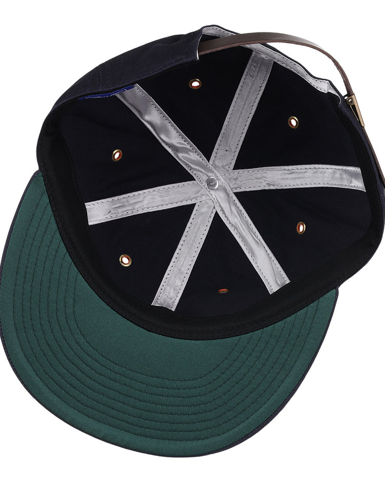 An inside look at the EFF New York Knights Cotton Twill Ballcap shows the green underbrim, black interior panels, silver cross-shaped stitching, ventilation eyelets, and an adjustable back strap—tribute to The Natural.