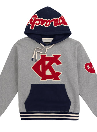 The EFF Kansas City Monarchs Vintage Inspired NLB Colorblock Hoodie features a gray and navy design, red and white KC logo, Supreme text on the hood, heart sleeve patch, striped cuffs—honoring the Negro National League Monarchs’ legacy.