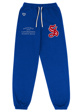 The EFF Santurce Cangrejeros Vintage Inspired Colorblock Jogger features blue fabric, white drawstrings, elastic cuffs, “SANTURCE 1939 CANGREJEROS PUERTO RICO” text, and a bold red and white S logo on the upper right leg.