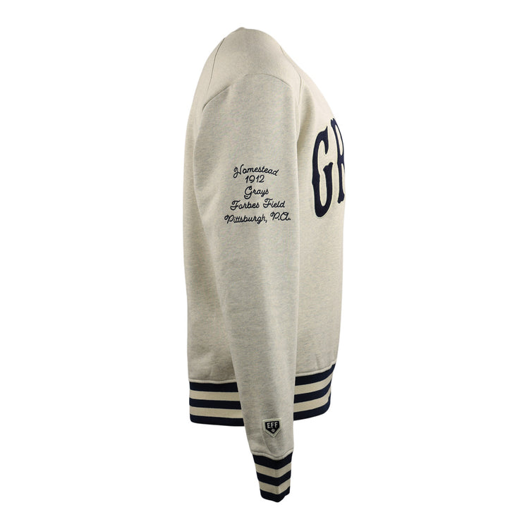 Side view of the EFF Homestead Grays NLB corduroy crewneck sweatshirt in light gray, featuring navy striped cuffs and hem, “GRY” on the front, Negro National League text on the sleeve, and a small patch above the cuff.