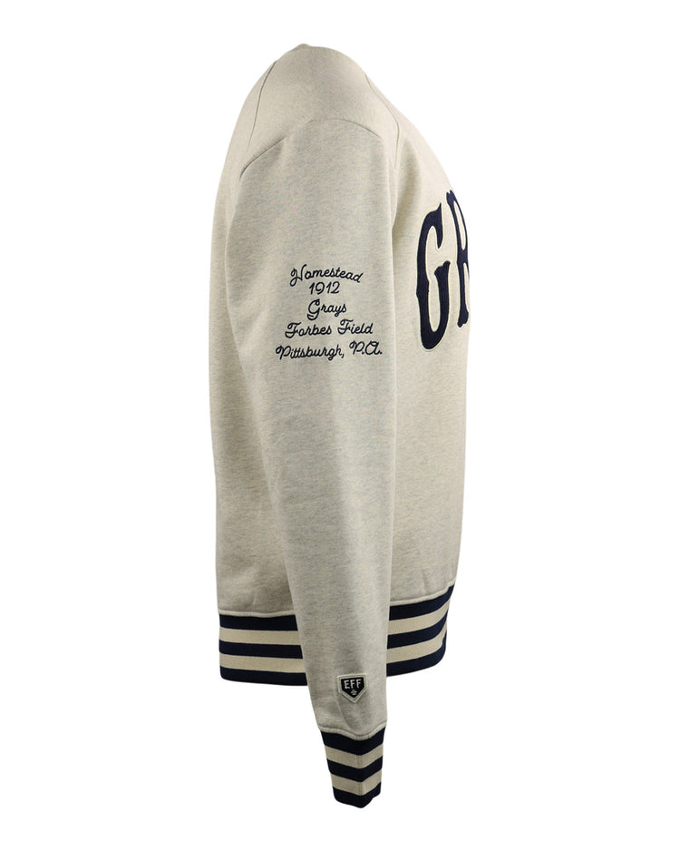 Side view of the EFF Homestead Grays NLB corduroy crewneck sweatshirt in light gray, featuring navy striped cuffs and hem, “GRY” on the front, Negro National League text on the sleeve, and a small patch above the cuff.