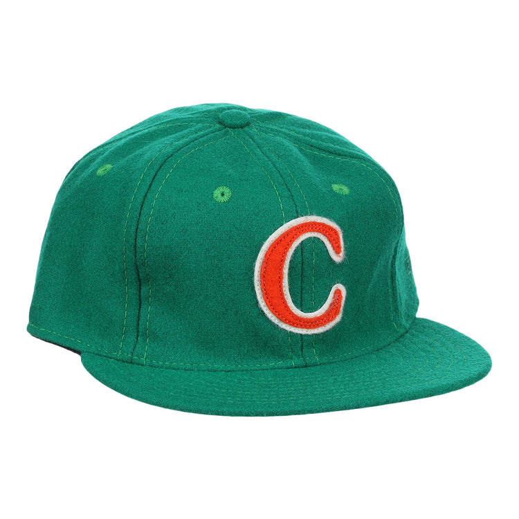 The Carrots Arlington Heights Collection “C Ballcap by Ebbets Field Flannels is a green, vintage-style wool cap with a curved brim and an orange and white embroidered “C” on the front.