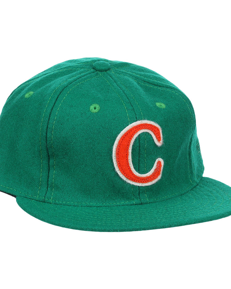 The Carrots Arlington Heights Collection “C Ballcap by Ebbets Field Flannels is a green, vintage-style wool cap with a curved brim and an orange and white embroidered “C” on the front.
