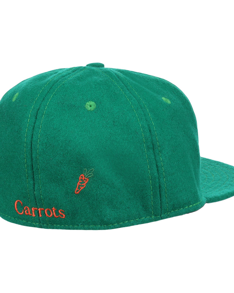 The Carrots Arlington Heights Collection “C Ballcap by Ebbets Field Flannels is a green suede baseball cap, shown from the back with orange Carrots embroidery and a small carrot graphic.