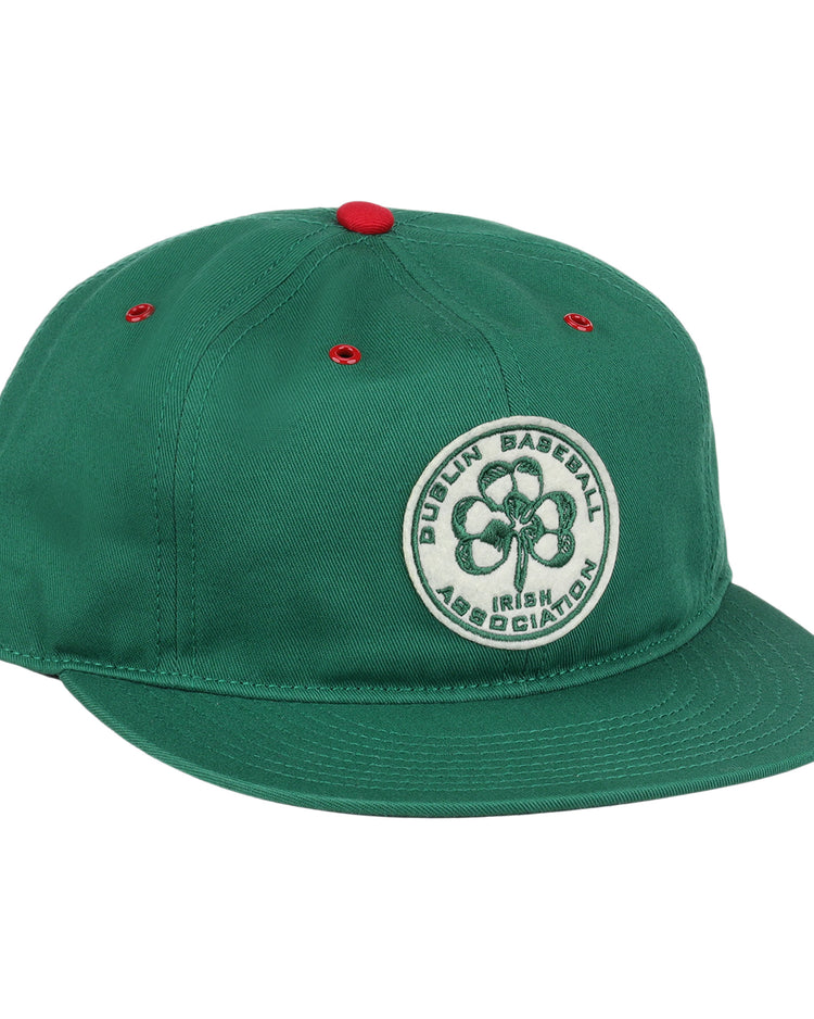 The EFF Dublin Irish Cotton Twill Ballcap is a green hat with red eyelets and a red top button, featuring a circular four-leaf clover patch and Dublin Baseball Irish Association on the front for classic Irish style.