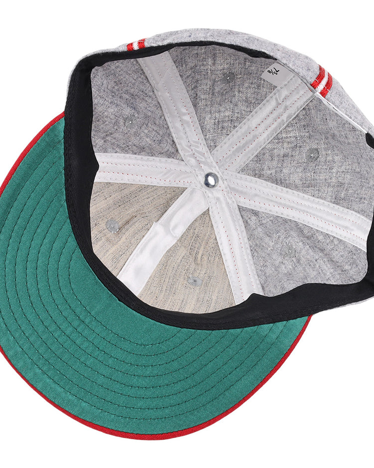 A top-down view of the Ebbets Field Flannels Daytona Beach Islanders 1936 Vintage Ballcap shows a gray cap with a green underside brim, red and white striped edges, and visible inner stitching and fabric panels.