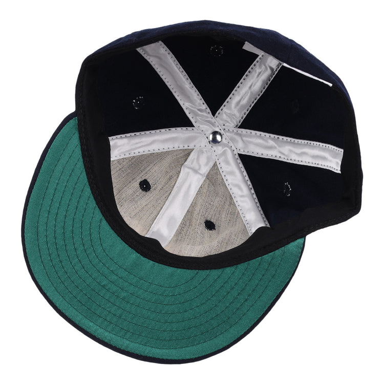 The image shows the inside of an EFF Winston-Salem Red Sox 1966 Vintage Ballcap, featuring a green brim and white stitching. The cap is upside down, displaying its structure and fabric panels.