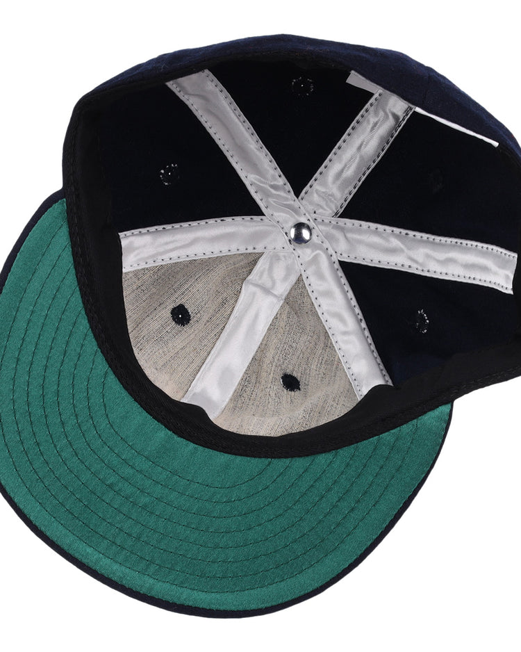 The image shows the inside of an EFF Winston-Salem Red Sox 1966 Vintage Ballcap, featuring a green brim and white stitching. The cap is upside down, displaying its structure and fabric panels.