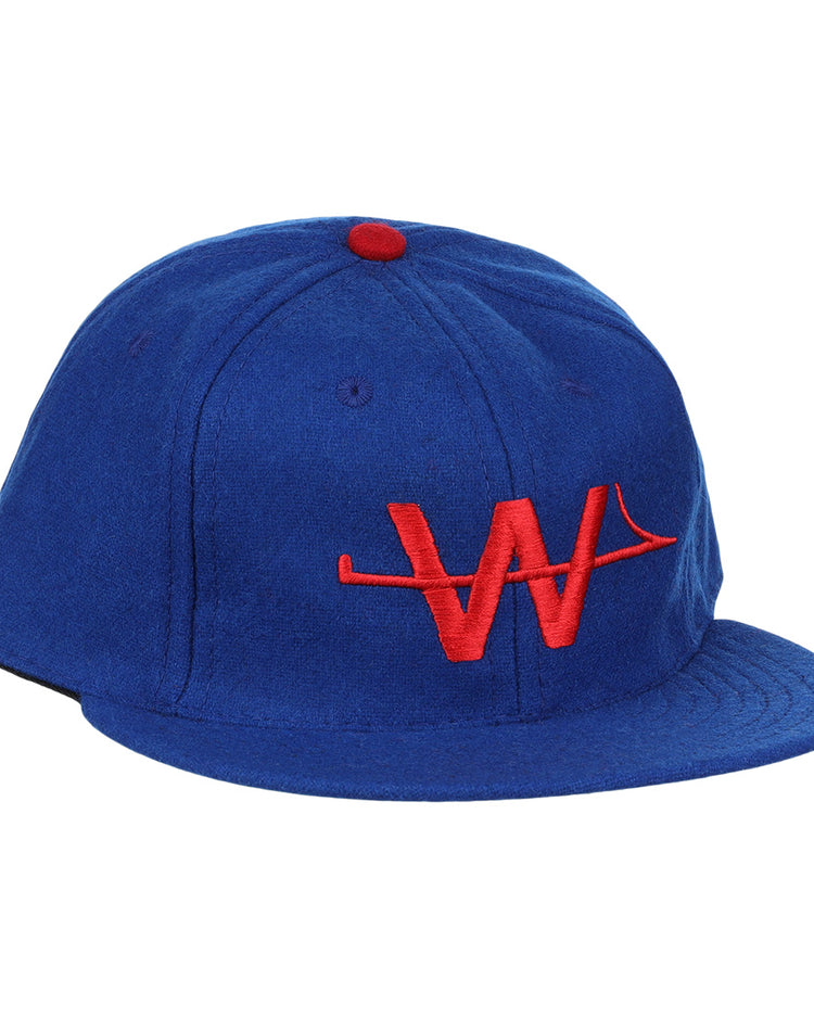 The EFF Wichita Aeros 1972 Vintage Ballcap is a blue cap with a red button and an embroidered red “W” logo on the front, authentically reproducing the classic style.