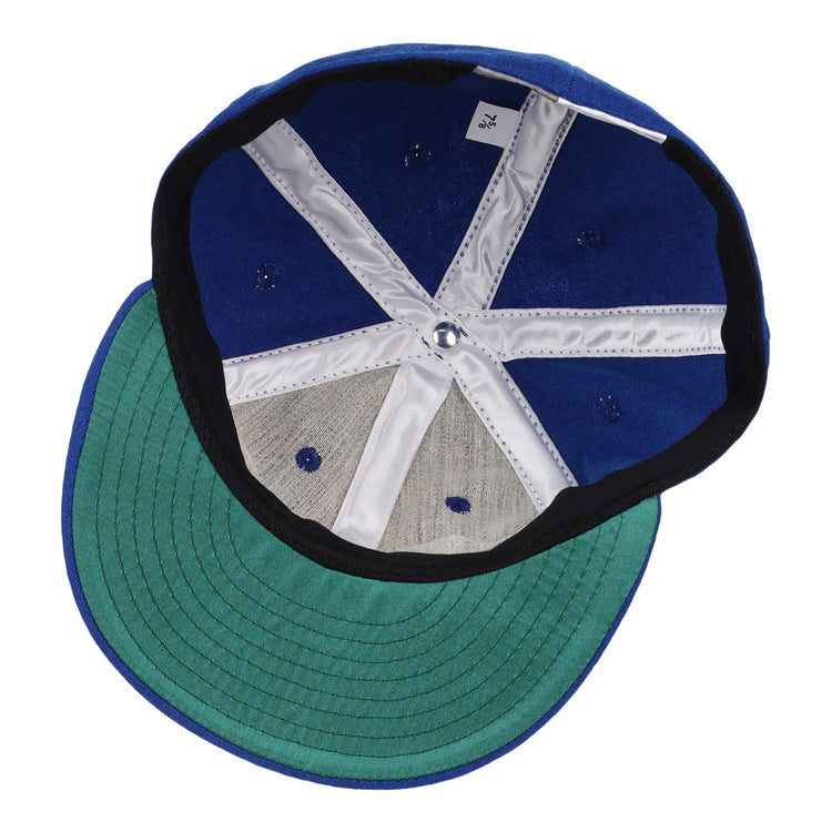 The image shows the inside of an EFF Oklahoma City 89ers 1994 Vintage Ballcap, featuring a blue crown, green underbrim, white and gray lining, visible stitching and ventilation holes, plus a small white tag on the inner band.