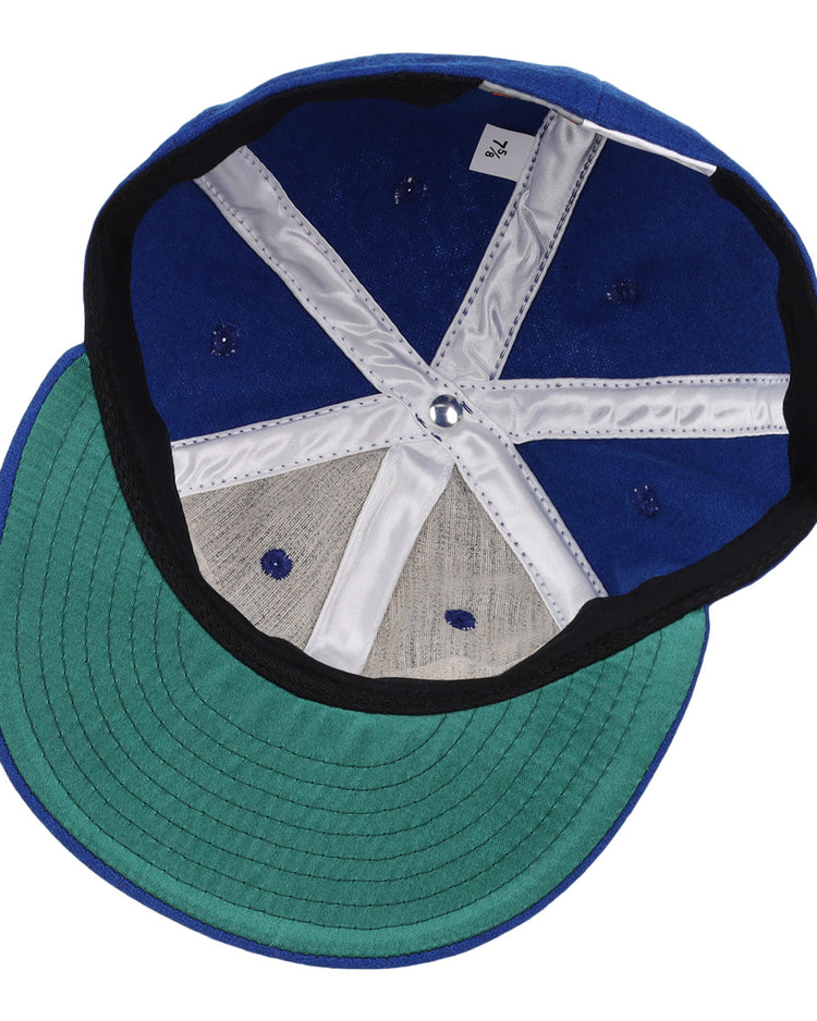 The image shows the inside of an EFF Oklahoma City 89ers 1994 Vintage Ballcap, featuring a blue crown, green underbrim, white and gray lining, visible stitching and ventilation holes, plus a small white tag on the inner band.