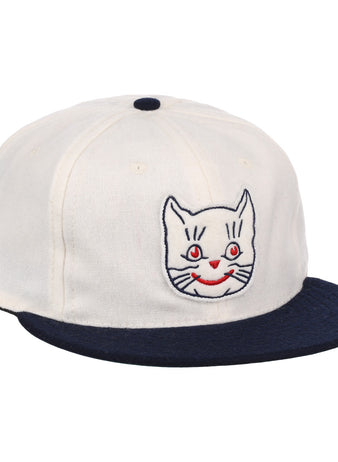 The EFF Kansas City Katz Off White Vintage Inspired Ballcap features a navy brim and button, plus an embroidered white cat face with red eyes and mouth—ideal for Katz ballcap collectors.