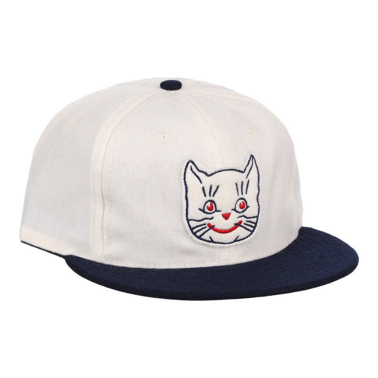 The EFF Kansas City Katz Off White Vintage Inspired Ballcap features a navy brim and button, plus an embroidered white cat face with red eyes and mouth—ideal for Katz ballcap collectors.