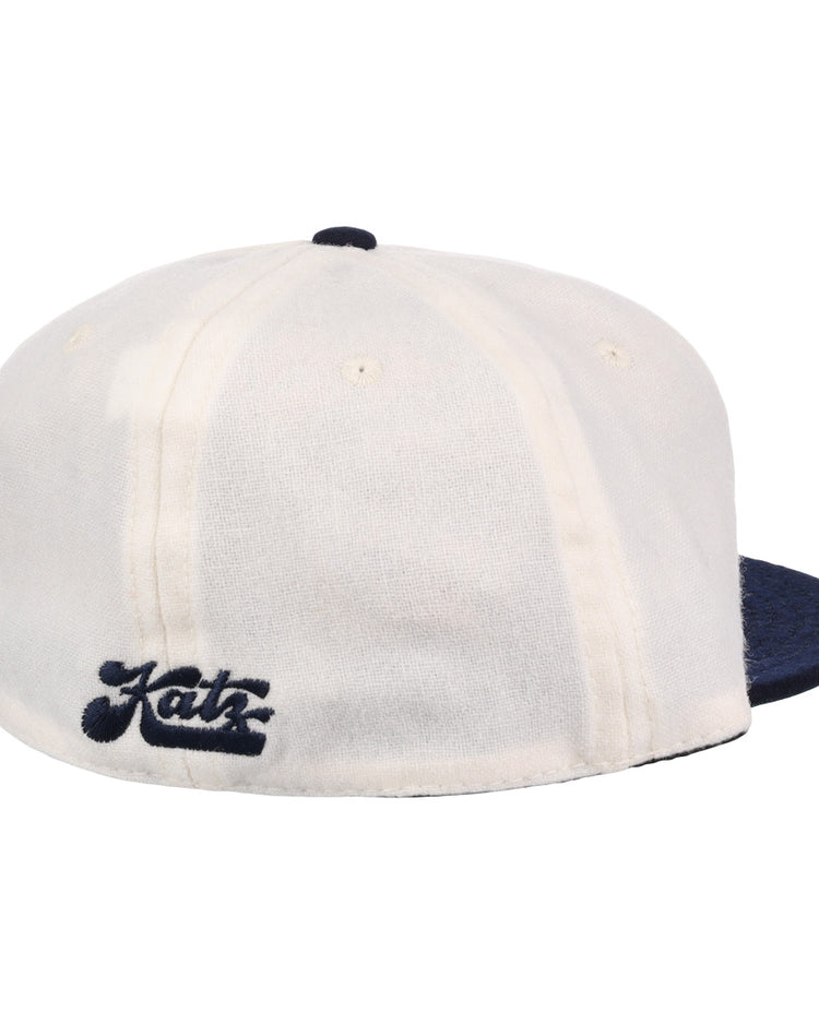 The EFF Kansas City Katz Off White Vintage Inspired Ballcap features a white crown, dark blue brim, and Katz in dark blue script on the back, modeled after the classic ballcap and shown against a plain white background.