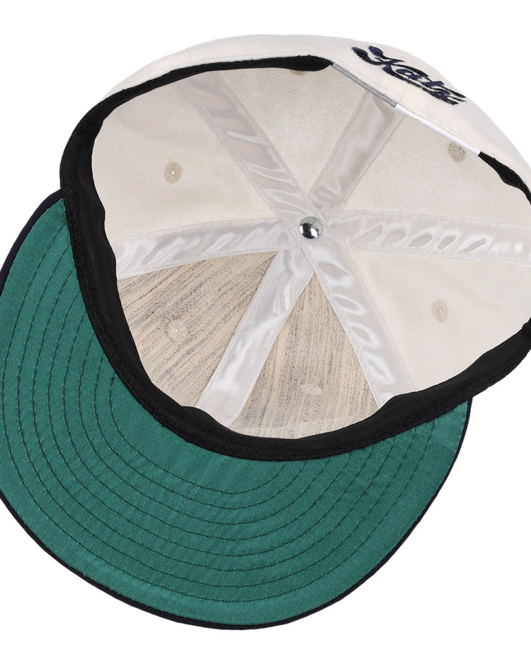 An inside view of the Kansas City Katz Off White Vintage Inspired Ballcap by EFF shows its green underbill, black trim, visible inner stitching and panels, plus a partially visible front logo reminiscent of classic Ban Johnson League style.