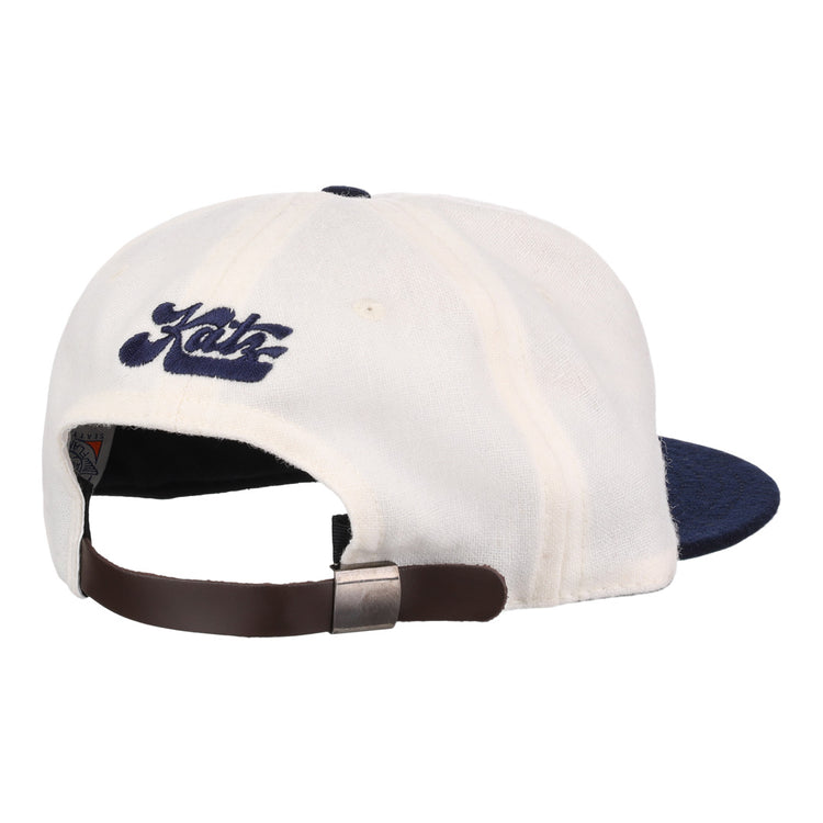 The EFF Kansas City Katz Off White Vintage Inspired Ballcap features a navy brim, brown adjustable strap with metallic clasp, and blue Katz embroidery above the back opening.