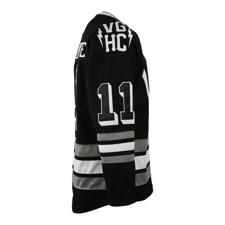 The EFF Violent Gentlemen x EFF Collection Hockey Jersey features a black design with white and gray stripes, number 11 on the right sleeve, and VGK HC with lightning bolts on the upper back—a standout in hockey apparel.