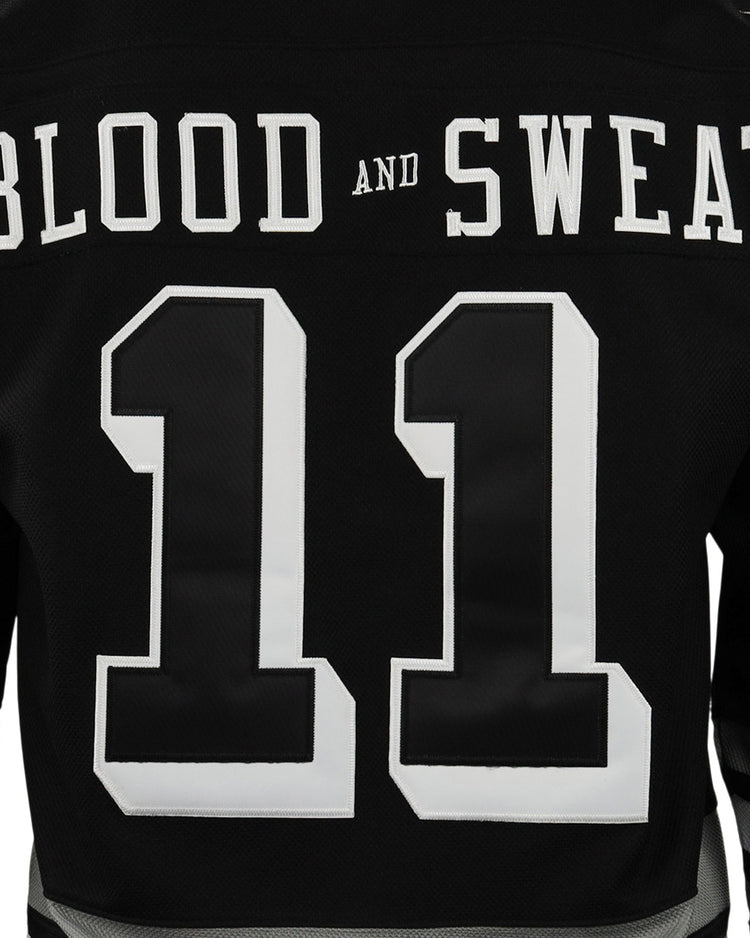 Back of an EFF Violent Gentlemen x EFF Collection Hockey Jersey in black, showing a large white number 11 and BLOOD AND SWEAT in bold white letters across the upper back, inspired by classic Violent Gentlemen designs.
