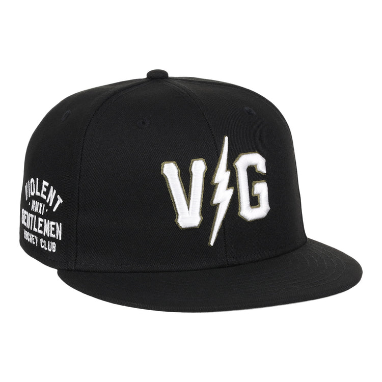 The EFF Violent Gentlemen x EFF Collection Fitted Ballcap is black with bold white VG letters split by a lightning bolt on the front and Violent Gentlemen Hockey Club on the side, part of the exclusive hockey apparel collection.