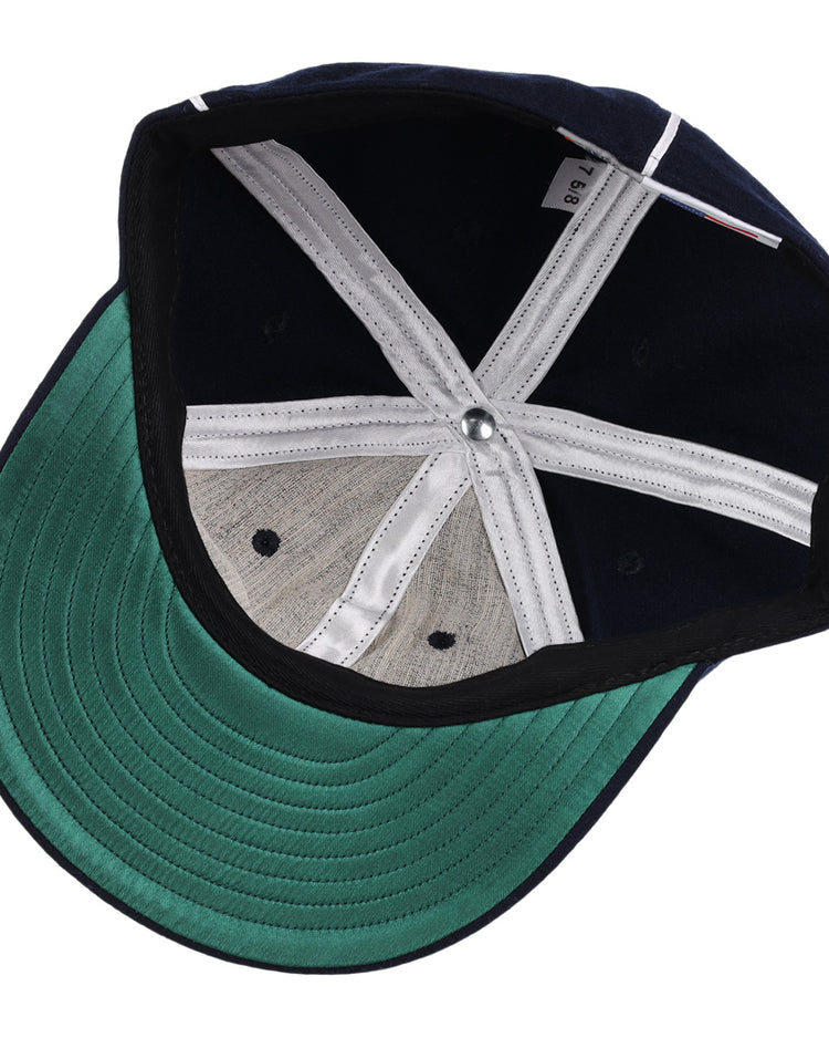 The image features the EFF Indianapolis Indians 1935 Vintage Ballcap, a navy blue cap with white stitched panels, a green underbrim, and a metal top button.