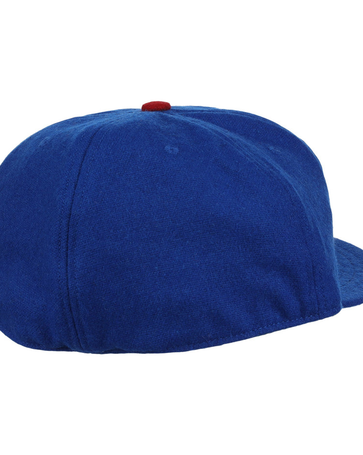 The EFF Tacoma Cubs 1969 Vintage Ballcap is a blue hat with a red button, seen from the back and side, featuring no visible logos—evoking the classic Pacific Coast League style.