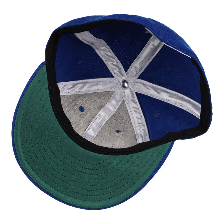 The image shows the inside of an EFF Tacoma Cubs 1969 Vintage Ballcap, featuring a green brim, white interior seam tape, ventilation holes, and visible fabric and stitching details.