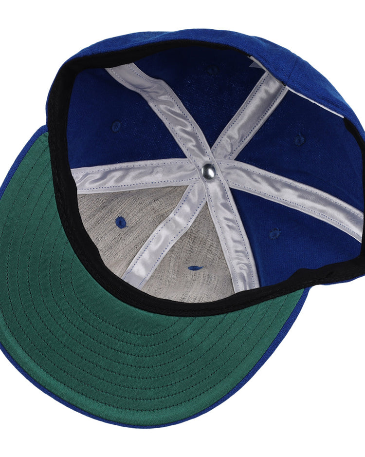 The image shows the inside of an EFF Tacoma Cubs 1969 Vintage Ballcap, featuring a green brim, white interior seam tape, ventilation holes, and visible fabric and stitching details.
