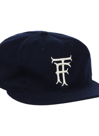 The EFF Twin Falls Cowboys 1947 Vintage Ballcap is a navy wool cap with a white, stylized TF logo embroidered on the front, inspired by the original 1947 design.