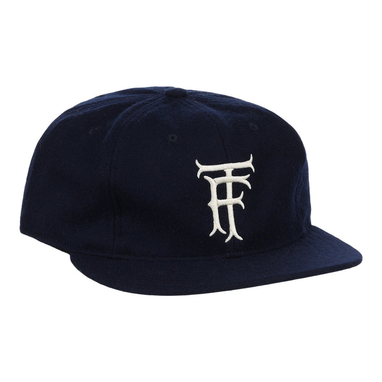 The EFF Twin Falls Cowboys 1947 Vintage Ballcap is a navy wool cap with a white, stylized TF logo embroidered on the front, inspired by the original 1947 design.