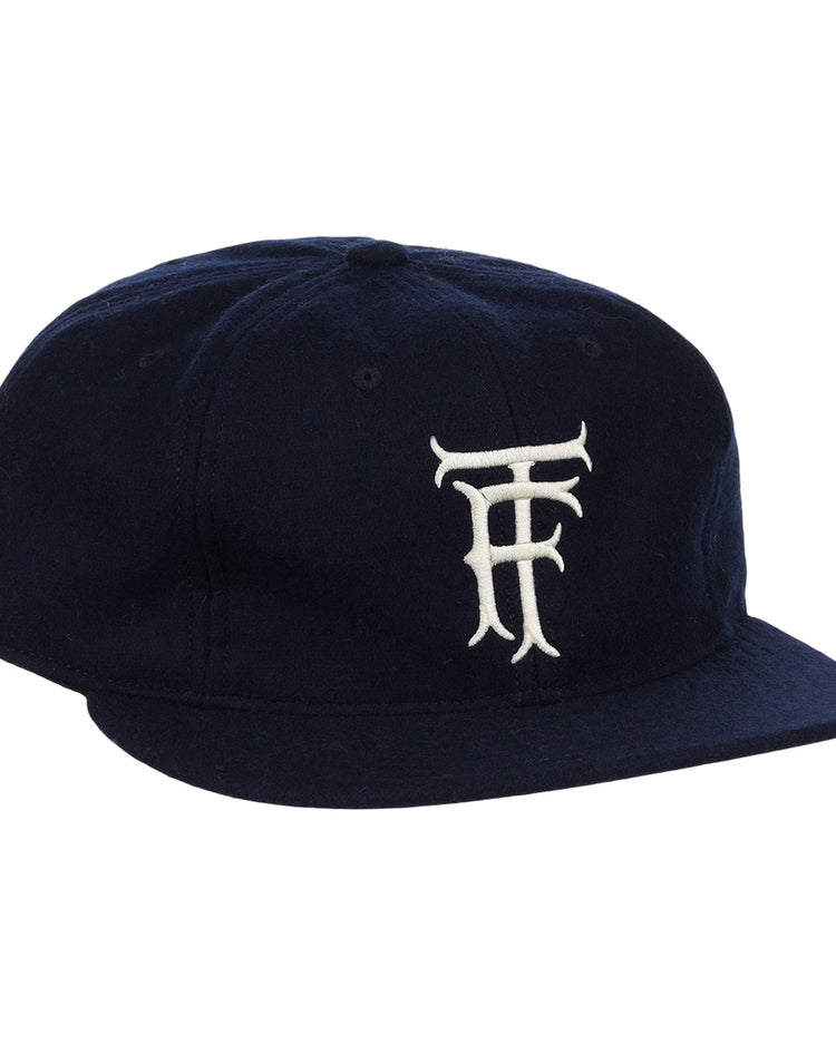 The EFF Twin Falls Cowboys 1947 Vintage Ballcap is a navy wool cap with a white, stylized TF logo embroidered on the front, inspired by the original 1947 design.