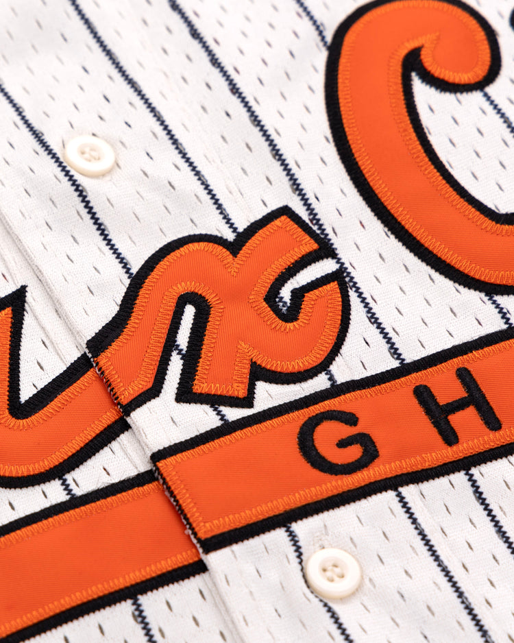 Close-up of the EFF Sioux City Ghosts EFF Pinstripe Button Down Jersey, featuring white pinstripes, orange and black embroidered GH lettering inspired by the Sioux City Ghosts, white buttons, and stitched details.