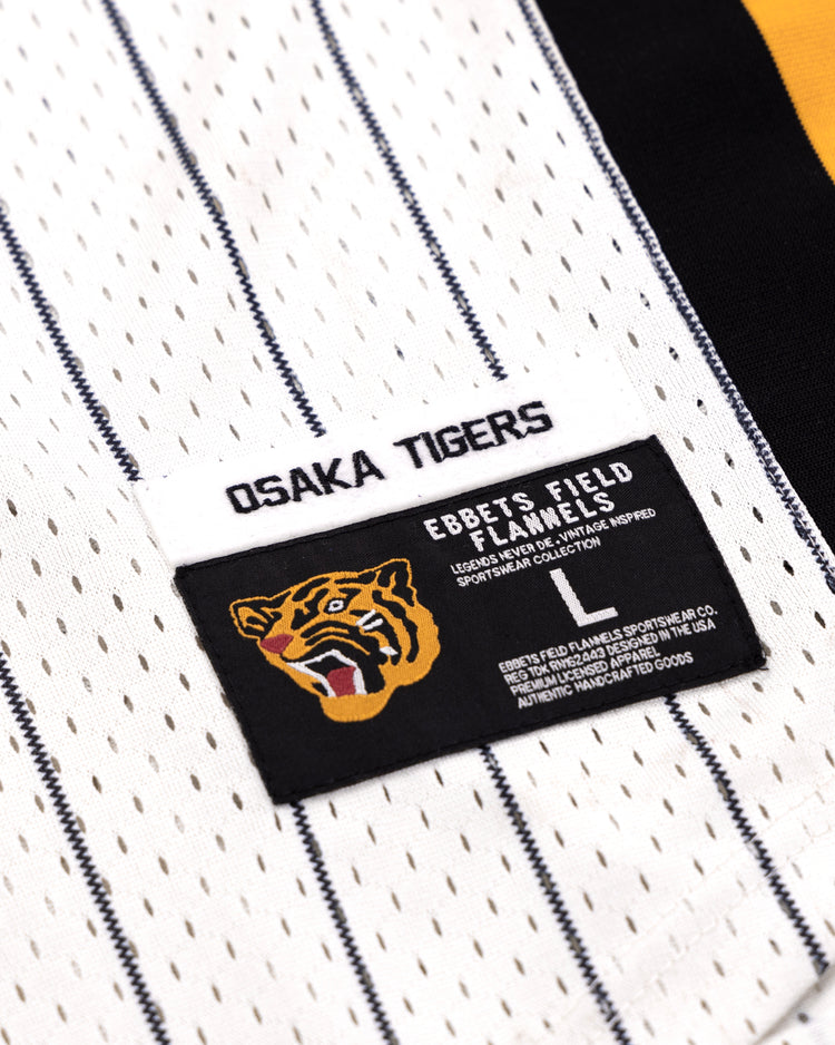 Close-up of the Osaka Tigers EFF Pinstripe Button Down Jersey by EFF, featuring OSAKA TIGERS lettering, a tiger logo patch, and distinctive labels. This classic pinstripe stands out among black baseball jerseys.