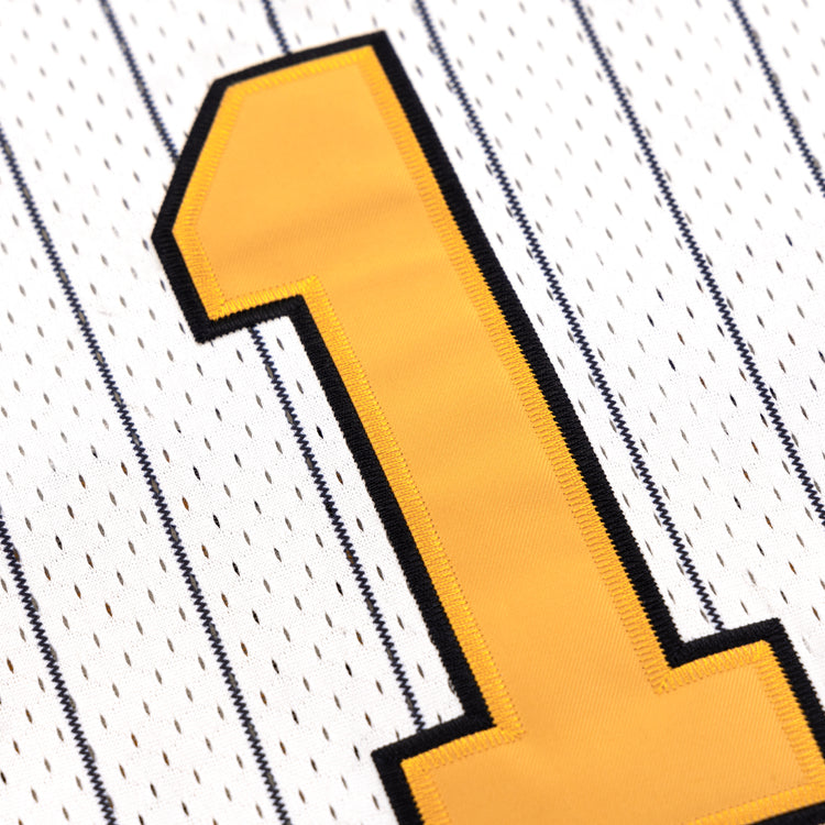 Close-up of a yellow number one outlined in black on the EFF Osaka Tigers EFF Pinstripe Button Down Jersey, featuring thin black stripes on white fabric.