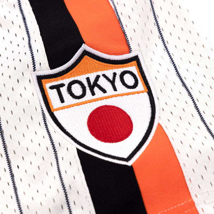 Close-up of the EFF Tokyo Giants Pinstripe Button Down Jersey, showcasing black, orange, and white stripes with a TOKYO patch above a red circle—paying tribute to the Tokyo Giants and Japans Black baseball heritage.