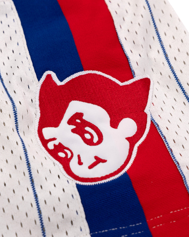 A close-up of the Sankei Atoms EFF Pinstripe Button Down Jersey by EFF shows white mesh with blue pinstripes, a red stripe, and a red and white cartoon face with bold eyebrows inspired by the Atom Boy jersey.