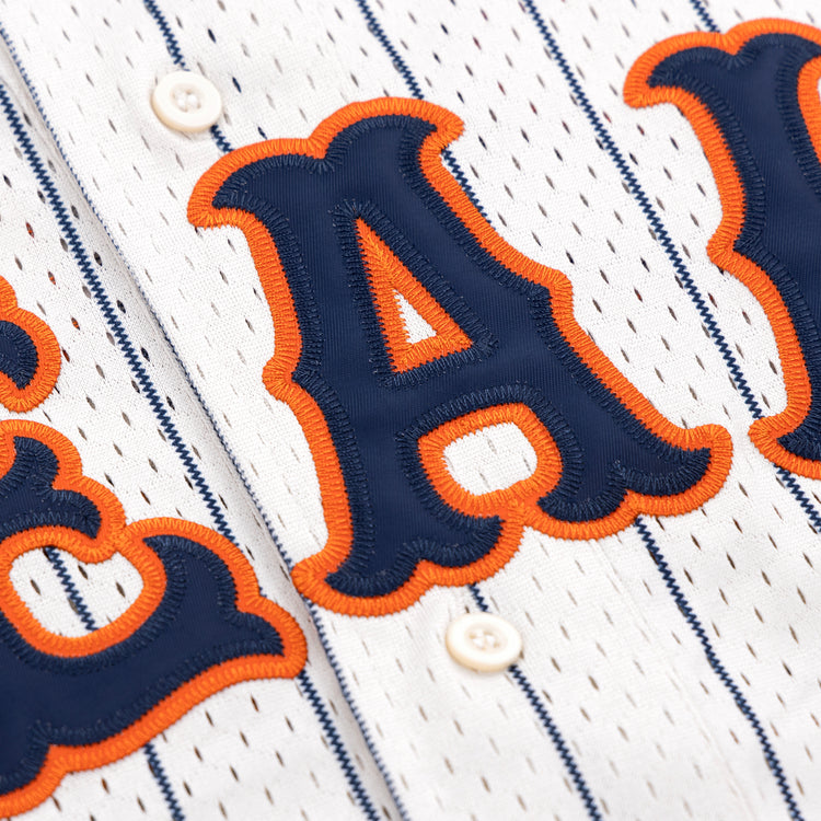 The EFF San Francisco Seals Pinstripe Button Down Jersey features blue vertical stripes, bold blue letters with orange embroidery, and two white front buttons—a classic tribute to the vintage Seals style.