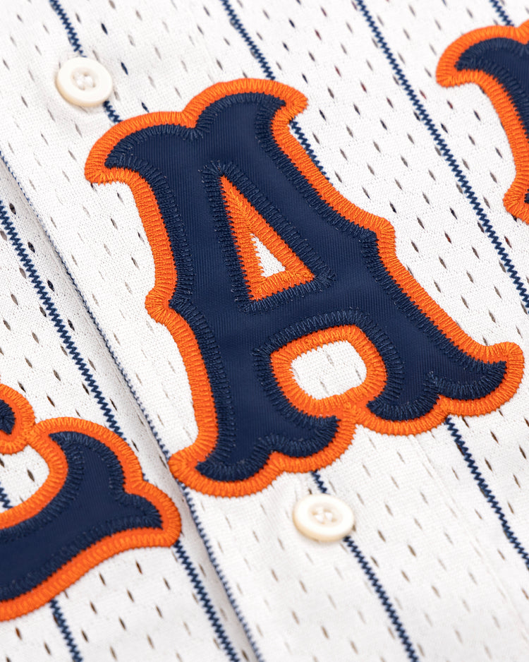 The EFF San Francisco Seals Pinstripe Button Down Jersey features blue vertical stripes, bold blue letters with orange embroidery, and two white front buttons—a classic tribute to the vintage Seals style.
