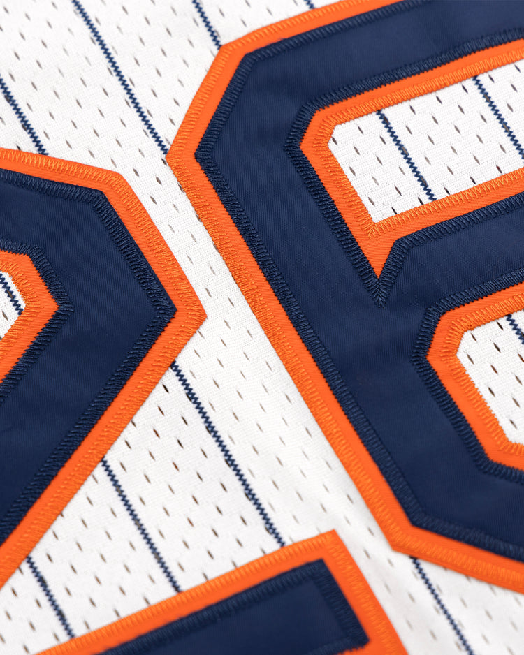 Close-up of the San Francisco Seals EFF Pinstripe Button Down Jersey by EFF, featuring thin blue pinstripes and large blue numbers outlined in orange stitching.