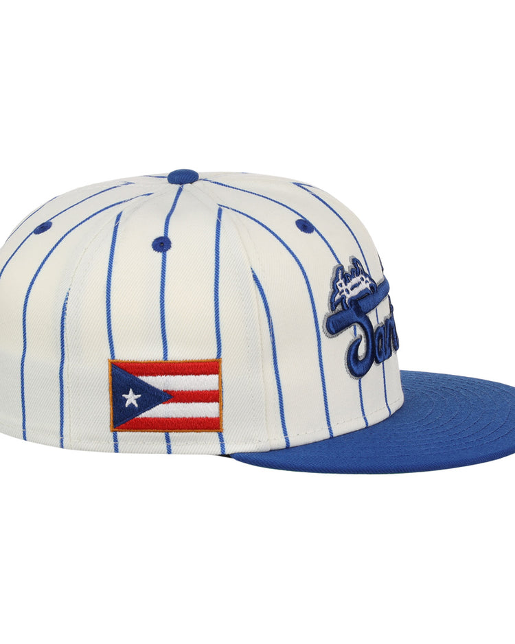 The EFF Santurce Cangrejeros Pinstripe Fitted Ballcap features a white base with blue pinstripes, a blue brim, and Puerto Rican League tribute patches including the Puerto Rican flag on the side.