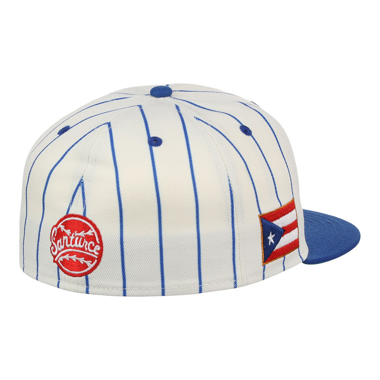 The EFF Santurce Cangrejeros Pinstripe Fitted Ballcap is a white cap with blue vertical pinstripes, a blue bill, a red circular logo patch, and a Puerto Rican flag patch on the side, honoring Puerto Rican League style.