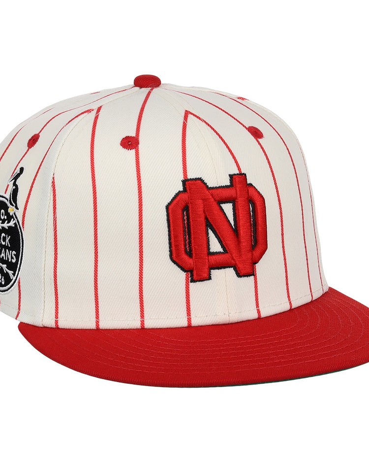 The EFF New Orleans Black Pelicans NLB Pinstripe Fitted Ballcap features red pinstripes, a solid red brim, a bold ND logo, and a black patch honoring the New Orleans Black Pelicans of the Negro Southern League.