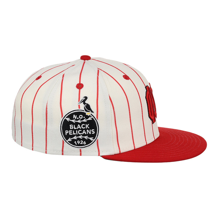 The EFF New Orleans Black Pelicans NLB Pinstripe Fitted Ballcap features a white pinstripe design, red brim, and side patch with “N.O. Black Pelicans 1926” and pelican graphic, honoring the Negro Southern League team.