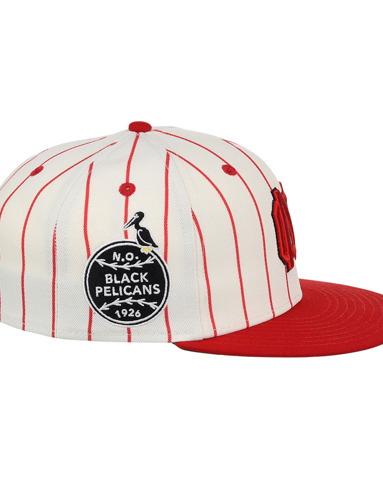 The EFF New Orleans Black Pelicans NLB Pinstripe Fitted Ballcap features a white pinstripe design, red brim, and side patch with “N.O. Black Pelicans 1926” and pelican graphic, honoring the Negro Southern League team.