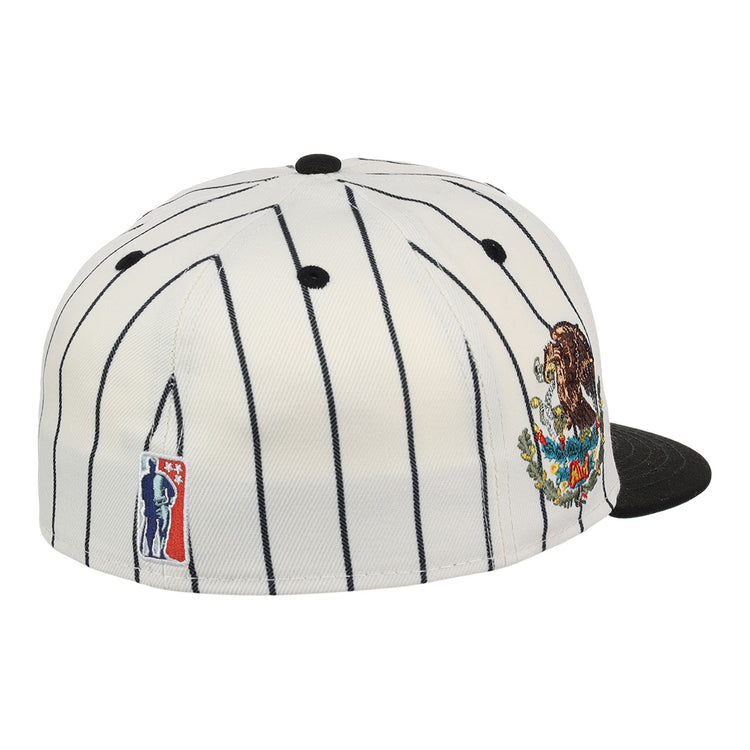 The EFF Veracruz NLB Pinstripe Fitted Ballcap is a white cap with thin black pinstripes, a black brim, a colorful bear and mountains patch on the side, and an embroidered NBA logo on the back.