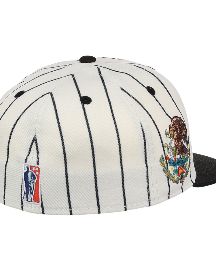 The EFF Veracruz NLB Pinstripe Fitted Ballcap is a white cap with thin black pinstripes, a black brim, a colorful bear and mountains patch on the side, and an embroidered NBA logo on the back.