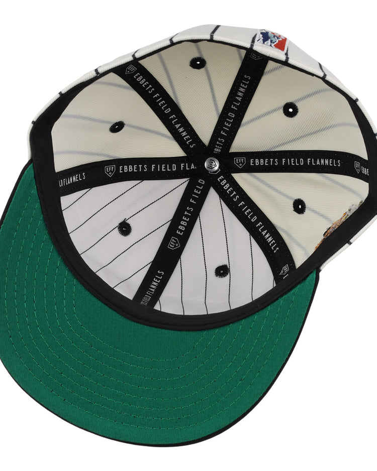 The underside of the Veracruz NLB Pinstripe Fitted Ballcap by EFF features a green brim, white inner panels with black pinstripes, black button details, and black bands labeled EBBETS FIELD FLANNELS.