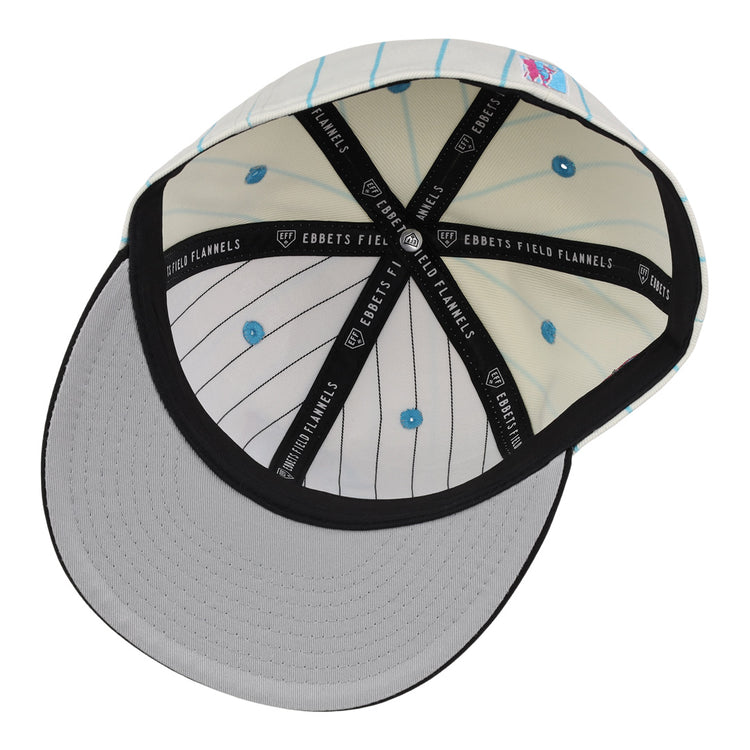 The EFF Miami Giants NLB Pinstripe Fitted Ballcap is shown from below, highlighting the gray underside of the brim, white crown with light blue pinstripes, blue eyelets, and black interior taping labeled EBBETS FIELD FLANNELS.